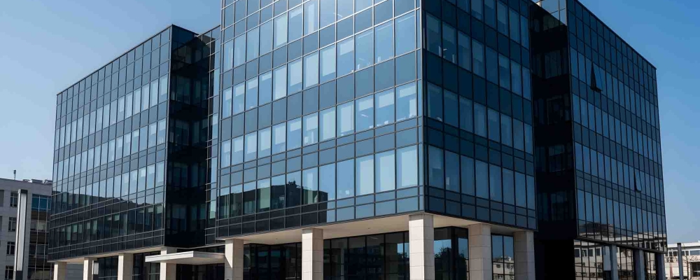 Modern Glass Office Building Exterior Under Clear Blue Sky: Cont